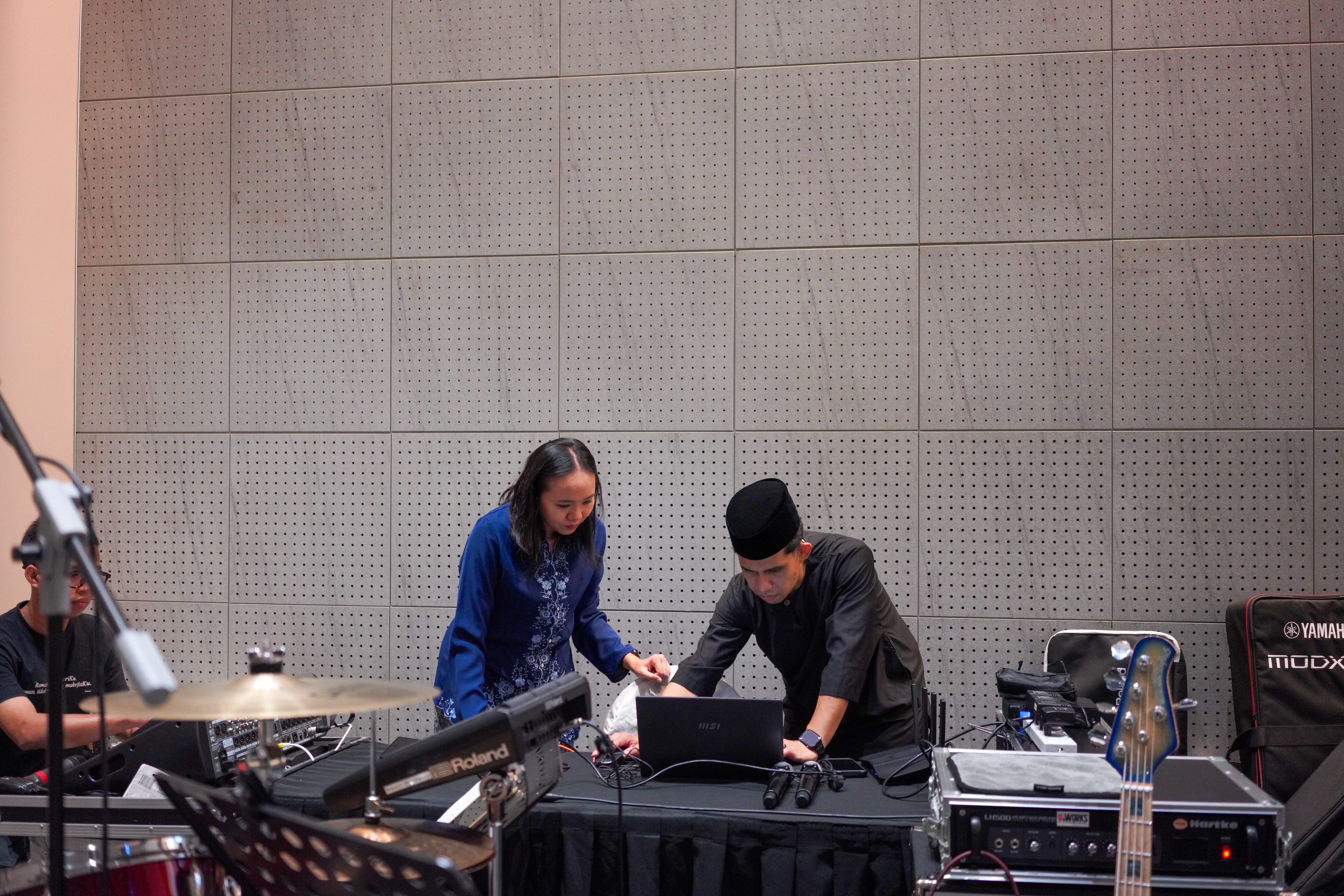 Events team conducting final checks on the audio and presentation systems before the start of the programme.